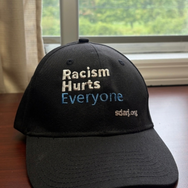 Racism Hurts Everyone – Cap