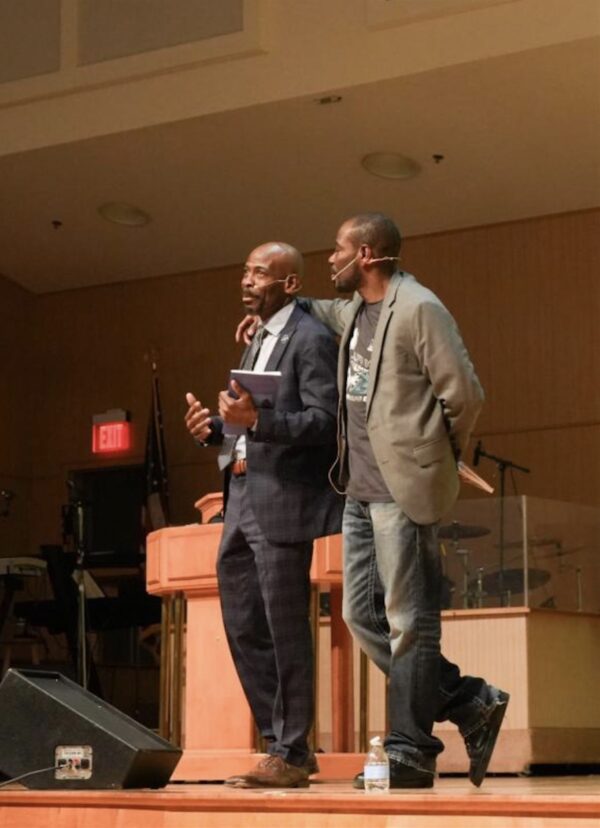 Nnamdi Chukwuocha, left, gets emotional and is embraced by brother Al Mills