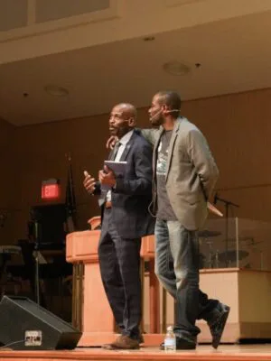 Nnamdi Chukwuocha, left, gets emotional and is embraced by brother Al Mills